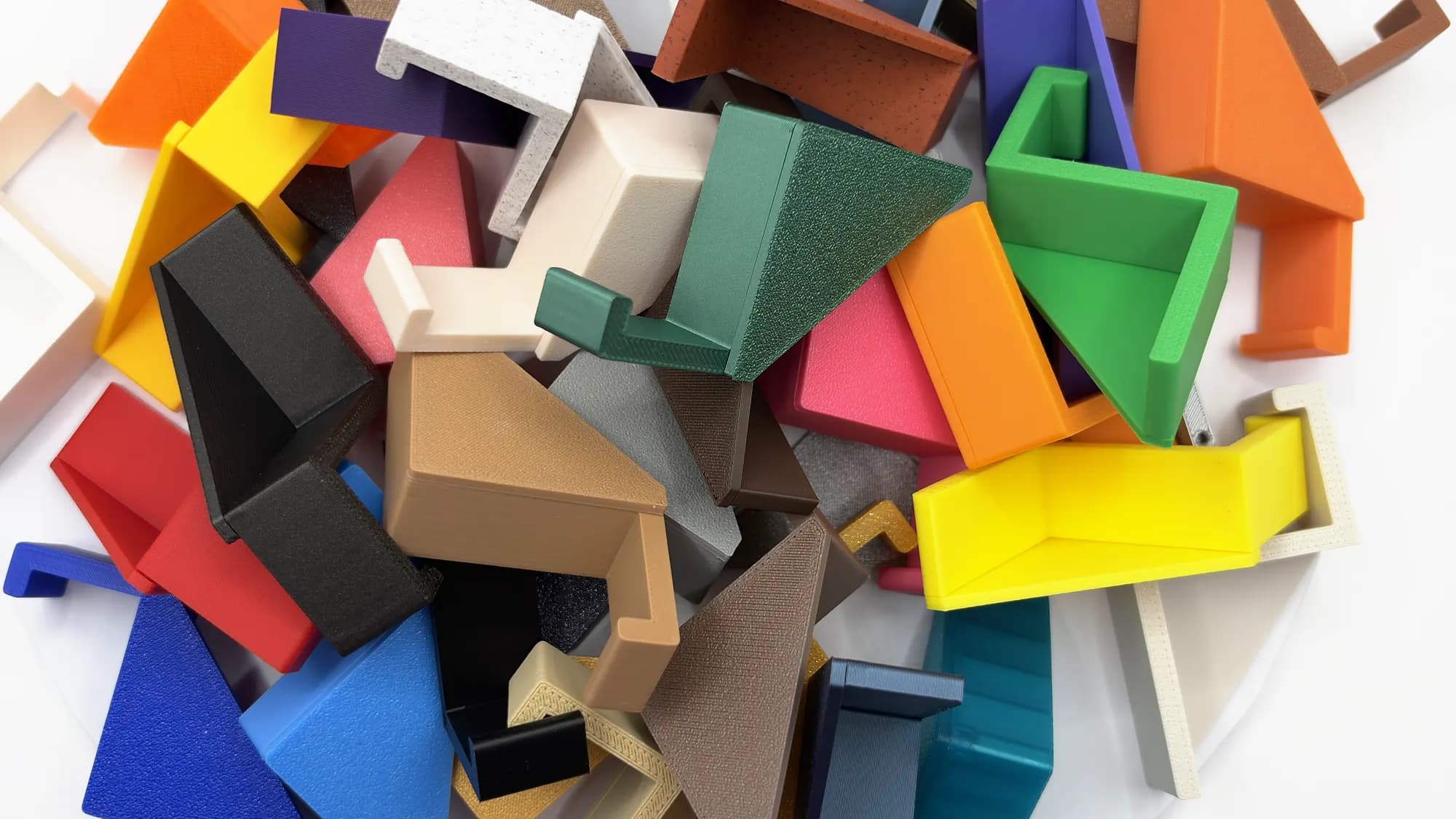 Headphone Hangers in a wide range of single colours, piled together