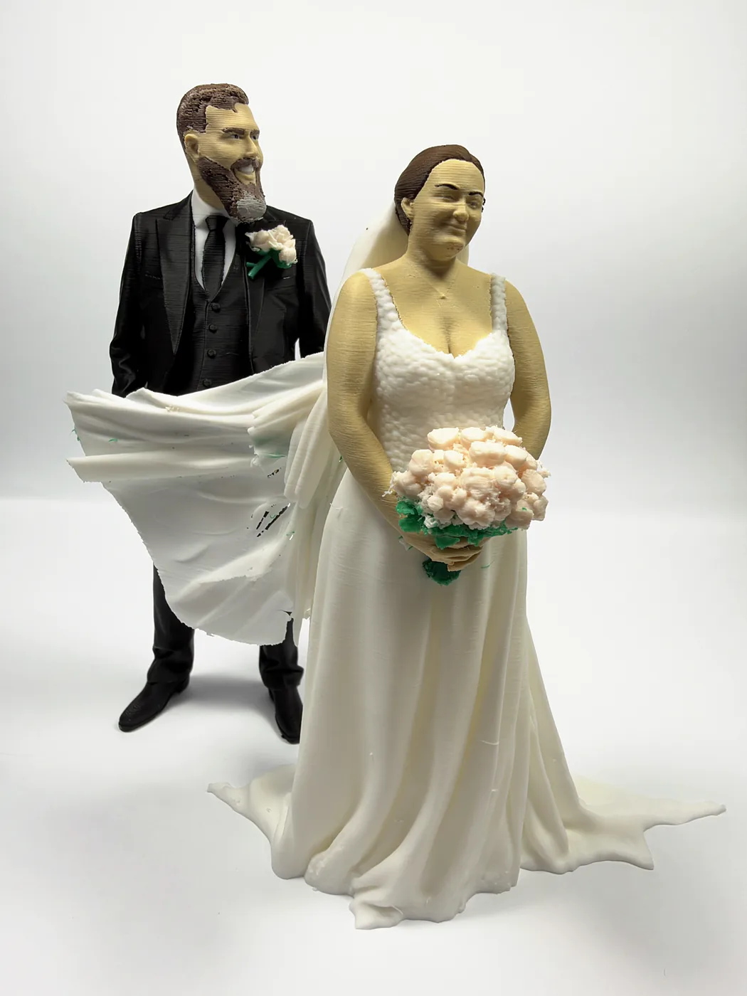 The bride and groom figures from the bride’s side, the groom standing just behind her