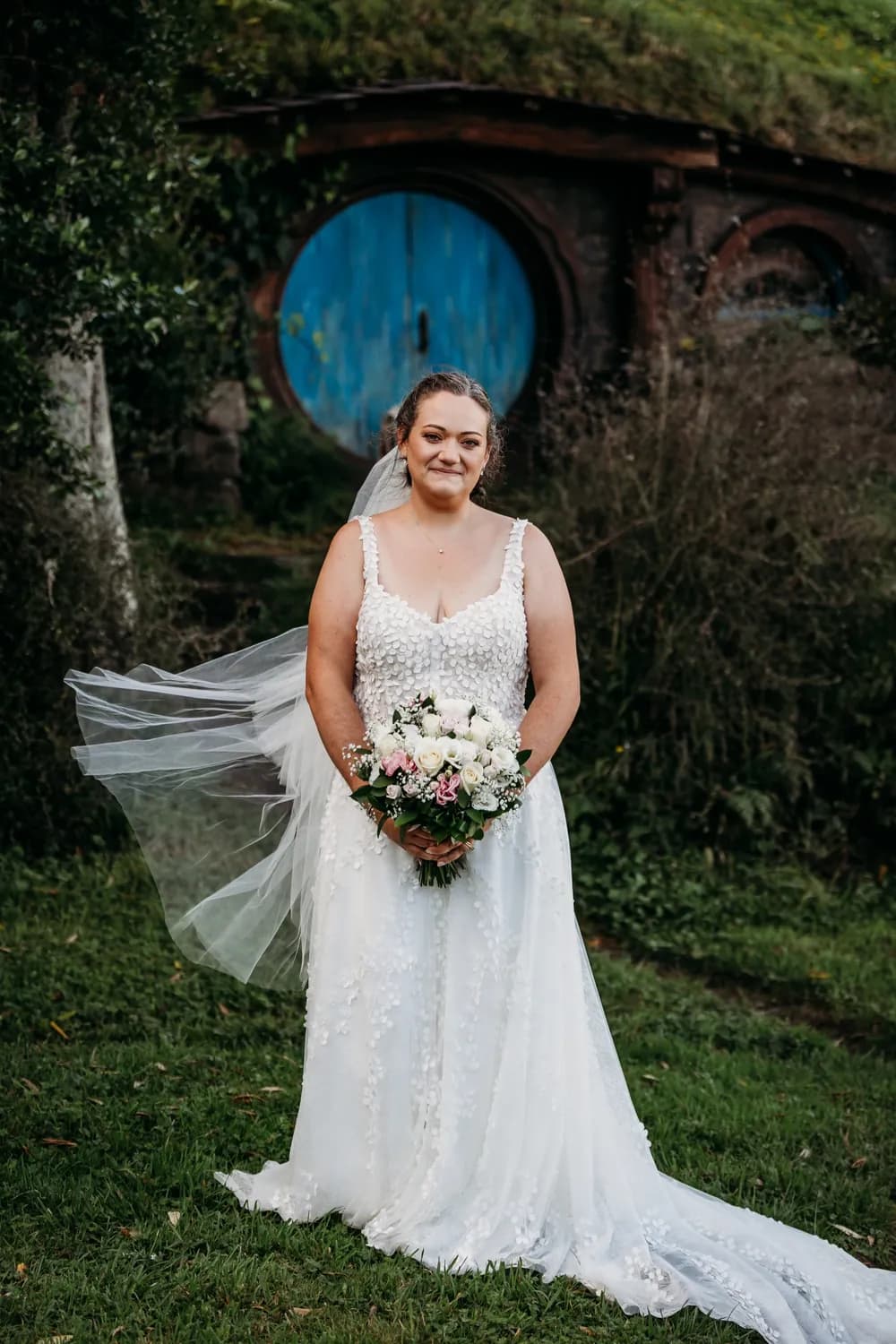 The bride on her wedding day, her veil lifted sideways by the wind