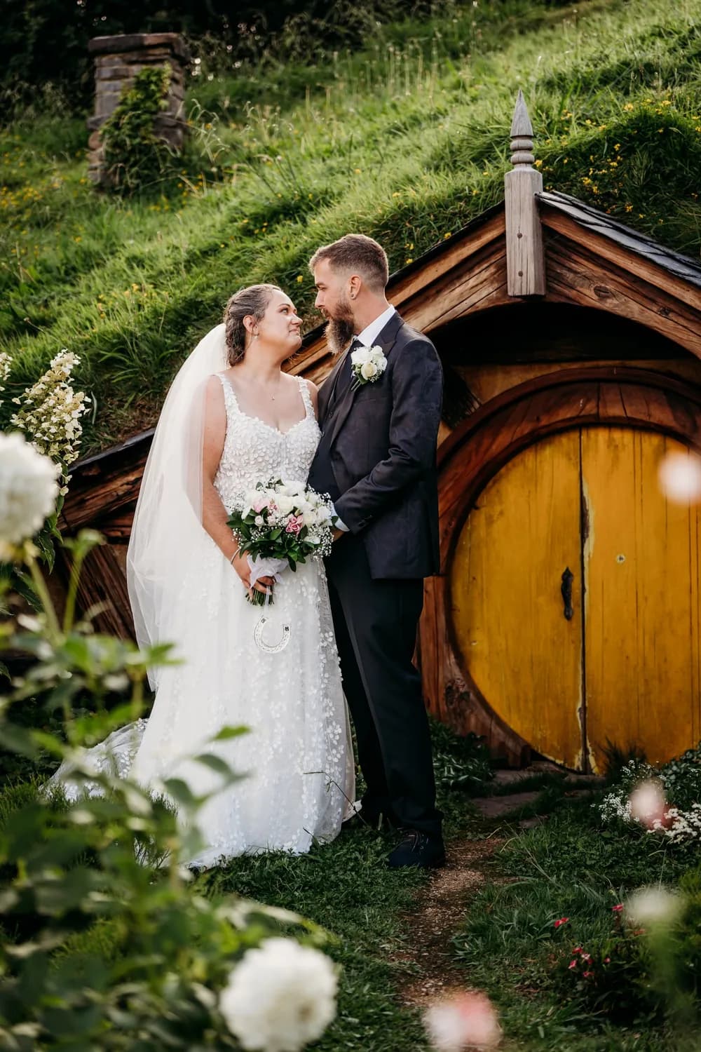 A bride and groom on their wedding day, turned towards each other